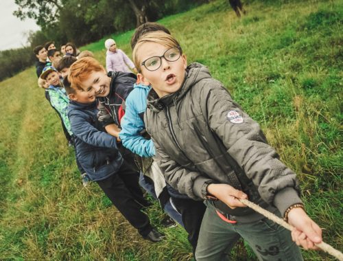 group of children pulling brown rope